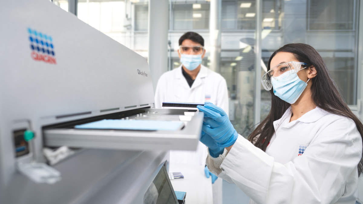 QIAcuity, digital PCD, dPCR, Labworker handling the instrument, loading tips, Chaimae Safi, Amit Singh, mask, wearing masks, labcoat